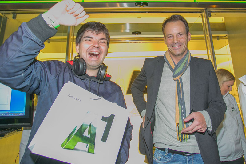 A1-Shop-Leiter Guido Lenz überreicht dem ersten Kunden ein iPhone 5.