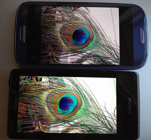 Das Display des Xperia T (unten im Bild) liefert kräftige, kontrastreiche Farben. Mit der Kamera aufgenommene Fotos wirken auf dem Display im direkten Vergleich mit dem Galaxy S3 eine Spur greller und weniger natürlich, obwohl dieser Unterschied bei den Aufnahmen am Monitor nicht so stark zu erkennen ist (sieht beide Testfotos unten).