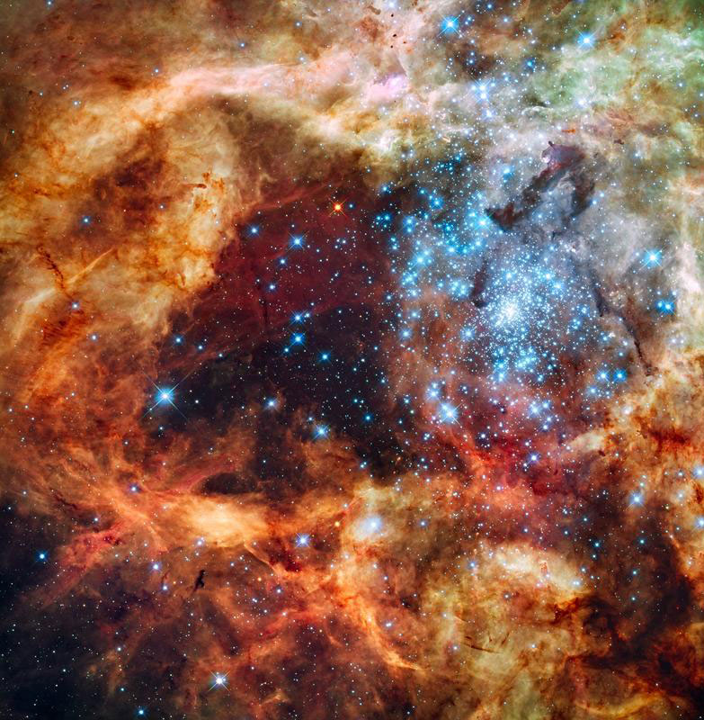 Blick auf den Sternhaufen R136: Blau ist das Licht von den heißesten und massereichsten Sternen, das Grün stammt von glühendem Sauerstoff und Rot von fluoreszierendem Wasserstoff.